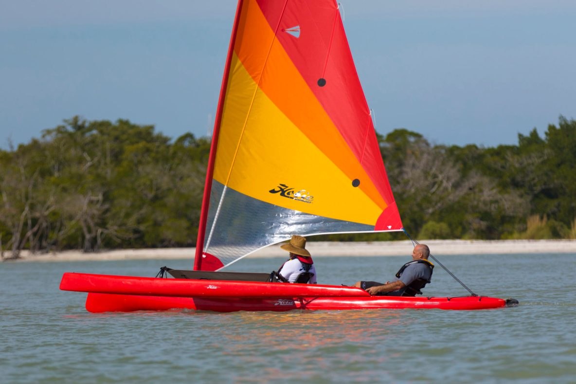 Two sailors aboard a Hobie Tandem Island with its sail set