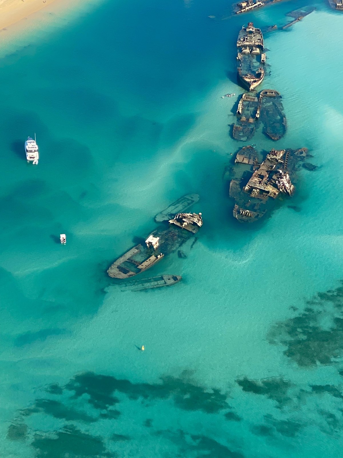 An aerial view of Tangalooma wrecks in clear turquoise water off Moreton Island